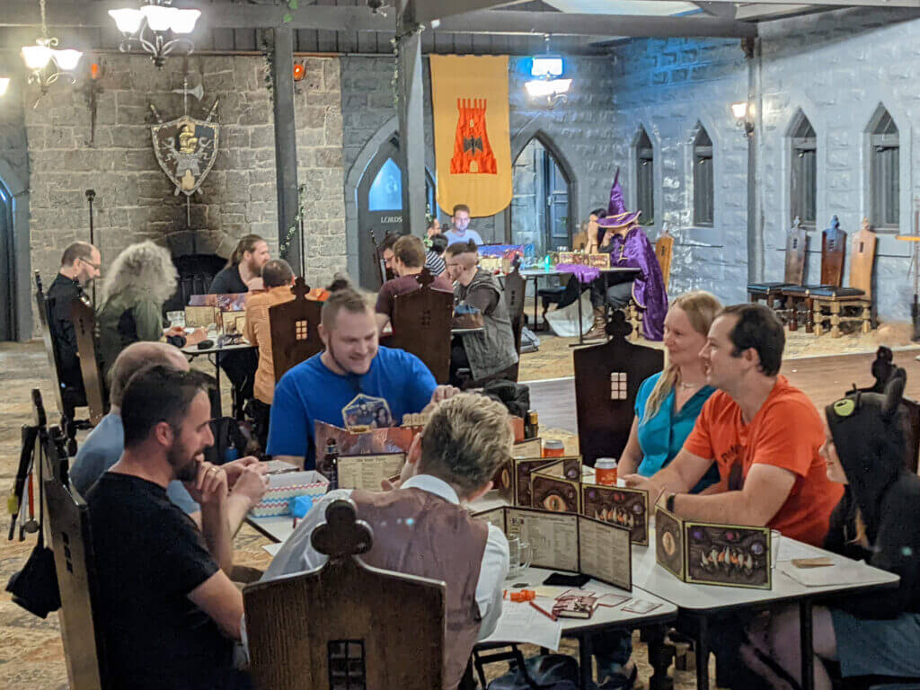 A group of attendees sitting in the Abbey Inn Tavern, playing Dungeons and Dragons.